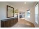 Hallway with hardwood floors, a large mirror over a console, and views into the dining area and stairwell at 3600 N Pecos St, Denver, CO 80211