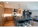 Bright kitchen showcasing an island with seating, granite countertops, custom cabinets, and stainless steel appliances at 3600 N Pecos St, Denver, CO 80211