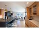 Open kitchen with an island and seating that flows into the living room with a fireplace at 3600 N Pecos St, Denver, CO 80211