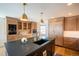 Gourmet kitchen featuring a large island with a sink and custom wood cabinetry at 3600 N Pecos St, Denver, CO 80211
