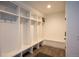 Bright mudroom features wood look floors, a bench and convenient custom storage cubbies, perfect for organization at 3600 N Pecos St, Denver, CO 80211