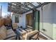 Outdoor patio with pavers, a fire pit, overhead string lights, and folding doors opening to the dining room at 3600 N Pecos St, Denver, CO 80211