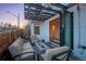 Outdoor patio with pavers, a fire pit, overhead string lights, and folding doors opening to the dining room at 3600 N Pecos St, Denver, CO 80211