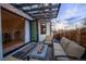 Outdoor patio with pavers, a fire pit, overhead string lights, and folding doors opening to the dining room at 3600 N Pecos St, Denver, CO 80211