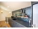 Modern wet bar with gray cabinetry, open shelving, tiled backsplash, and beverage cooler at 3600 N Pecos St, Denver, CO 80211