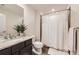 Inviting bathroom with granite countertop, shower with curtain and decorative plant at 6063 Eldora St, Golden, CO 80403