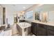 Bright bathroom with soaking tub, double vanity with granite countertops and plenty of natural light at 6063 Eldora St, Golden, CO 80403