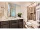 Elegant bathroom boasts a granite countertop, wood-look tile, and shower at 6063 Eldora St, Golden, CO 80403