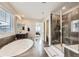 Spacious bathroom featuring a large soaking tub and separate glass-enclosed shower at 6063 Eldora St, Golden, CO 80403