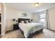 Well-lit bedroom featuring a large window, plush carpet, and a comfortable bed at 6063 Eldora St, Golden, CO 80403
