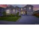 Charming two-story home with a well-manicured lawn, stone accents, and a cozy front porch at 6063 Eldora St, Golden, CO 80403