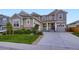 Charming two-story home with a well-manicured lawn, stone accents, and a cozy front porch at 6063 Eldora St, Golden, CO 80403