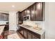 Modern kitchen features granite countertops, a subway tile backsplash, and sleek dark wood cabinetry at 6063 Eldora St, Golden, CO 80403