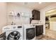 This laundry room is well organized with shelves and adjacent walk-in closet at 6063 Eldora St, Golden, CO 80403