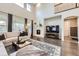 Bright living room boasts soaring ceilings, a fireplace, and elegant hardwood floors at 6063 Eldora St, Golden, CO 80403