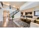 Spacious living room features a staircase with iron railings and an open floor plan at 6063 Eldora St, Golden, CO 80403