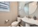 Stylish powder room with a pedestal sink, neutral paint, and decorative mirror at 6063 Eldora St, Golden, CO 80403