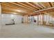 Unfinished basement with exposed beams and a treadmill at 9353 Middle Fork St, Littleton, CO 80125