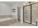 Bright bathroom featuring a walk-in shower, soaking tub, and modern fixtures at 9353 Middle Fork St, Littleton, CO 80125