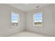 Bedroom with two windows providing natural light and a scenic outdoor view at 9353 Middle Fork St, Littleton, CO 80125
