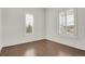 Bright bedroom features beautiful wood floors, white trim, and sun-filled windows with bright white plantation shutters at 9353 Middle Fork St, Littleton, CO 80125