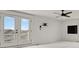 Bright bedroom featuring double doors to a balcony, and a ceiling fan at 9353 Middle Fork St, Littleton, CO 80125