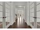 Elegant entryway with hardwood floors and glass paneled doors fills the home with light at 9353 Middle Fork St, Littleton, CO 80125