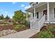 Charming home featuring a welcoming front porch and beautifully landscaped yard at 9353 Middle Fork St, Littleton, CO 80125