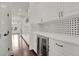 Modern kitchen featuring white cabinetry, a wine fridge, bronze hardware, and mosaic-style tile backsplash at 9353 Middle Fork St, Littleton, CO 80125