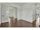 Spacious living room with dark wood flooring, bright white trim, and double french doors to an adjacent room at 9353 Middle Fork St, Littleton, CO 80125