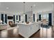 Open-concept design featuring a living room with a fireplace and a kitchen island with barstool seating at 9353 Middle Fork St, Littleton, CO 80125