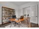 Bright home office with sleek wooden desk, built-in shelving and decorative rug at 9353 Middle Fork St, Littleton, CO 80125
