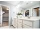 Elegant bathroom with double vanity and access to walk-in closet at 7924 Florado St, Denver, CO 80221