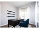 Home office with desk, chair, floating shelves, and window at 7924 Florado St, Denver, CO 80221