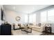 Bright living room with beige couch, two armchairs, and a coffee table at 7924 Florado St, Denver, CO 80221