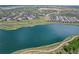 Picturesque aerial view of the lake with walking trails surrounding it and a community in the distance at 5226 Inland Ave, Firestone, CO 80504