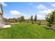 A spacious, well-maintained backyard featuring lush green grass and a wooden fence surrounding the perimeter at 5226 Inland Ave, Firestone, CO 80504