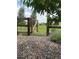 A rustic wooden gate opens to a large grassy common area in a neighborhood with gravel and lavender plants at 5226 Inland Ave, Firestone, CO 80504