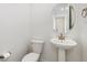 Half bathroom featuring modern fixtures, a pedestal sink, and a clean design at 5226 Inland Ave, Firestone, CO 80504
