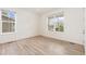 Bright bedroom with large windows, light hardwood floors and neutral colors at 5226 Inland Ave, Firestone, CO 80504