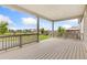 View of a covered deck with light colored wood and railings overlooking a grassy lawn with neighborhood views at 5226 Inland Ave, Firestone, CO 80504