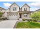 Charming two-story home with a front porch, attached garage, and well-manicured lawn at 5226 Inland Ave, Firestone, CO 80504