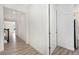 Bright hallway with hardwood floors leading to various rooms in the house at 5226 Inland Ave, Firestone, CO 80504