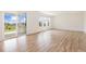Bright living room with light wood flooring, large sliding glass door to a covered patio, and multiple windows at 5226 Inland Ave, Firestone, CO 80504
