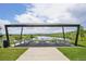 Community picnic area that offers shaded seating with views of the lake and the surrounding green space at 5226 Inland Ave, Firestone, CO 80504