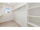 Walk-in closet with shelving and a window for natural light at 5226 Inland Ave, Firestone, CO 80504