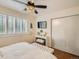 Bright bedroom with a crystal fan, sleek furniture, and natural light from shuttered windows at 11275 Holly St, Thornton, CO 80233