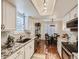 Bright kitchen featuring stainless steel appliances, granite countertops, and a view to the dining area at 11275 Holly St, Thornton, CO 80233