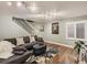 Relaxing living room with a comfortable gray sofa, stylish rug, and ample natural light from the window at 11275 Holly St, Thornton, CO 80233