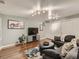 Cozy living room with a stylish gray sofa, ottoman, and a modern entertainment center, perfect for relaxing at 11275 Holly St, Thornton, CO 80233